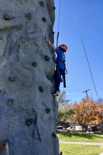 Student on a climbing wall outside