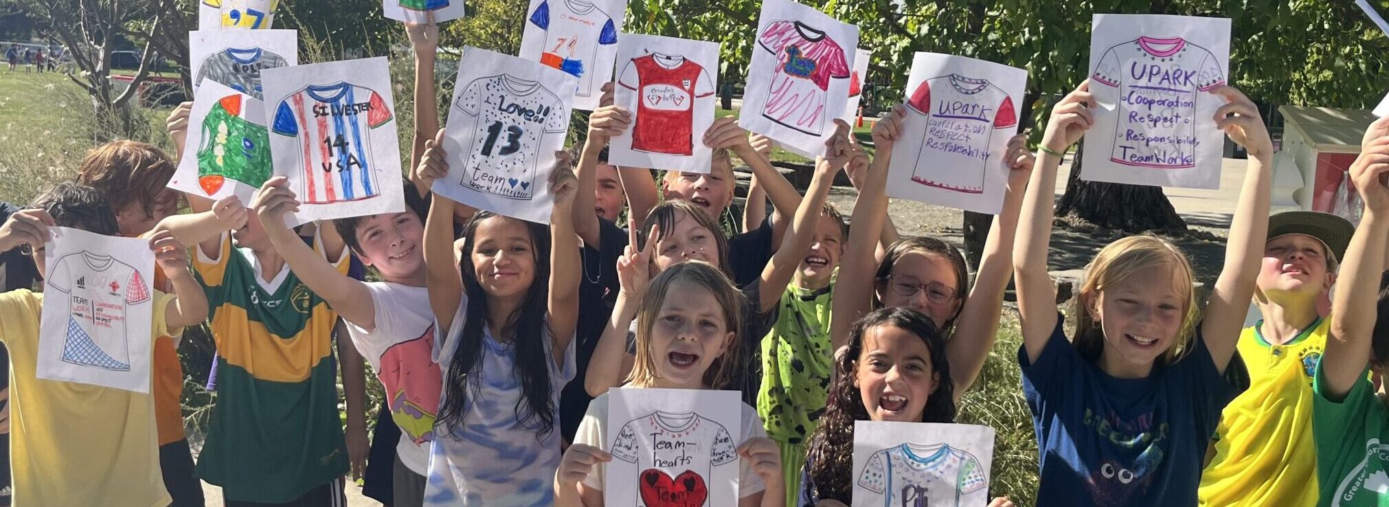 Children holding artwork